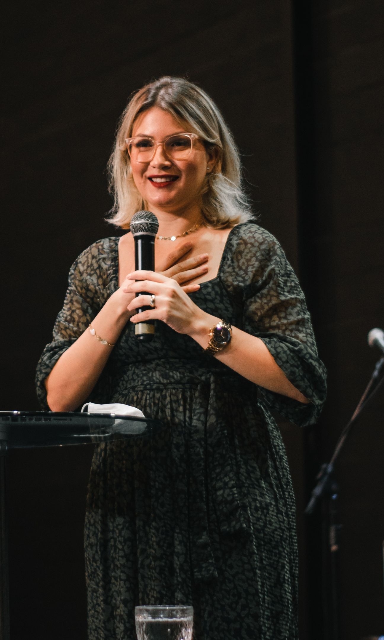 A speaker on stage, mid-talk